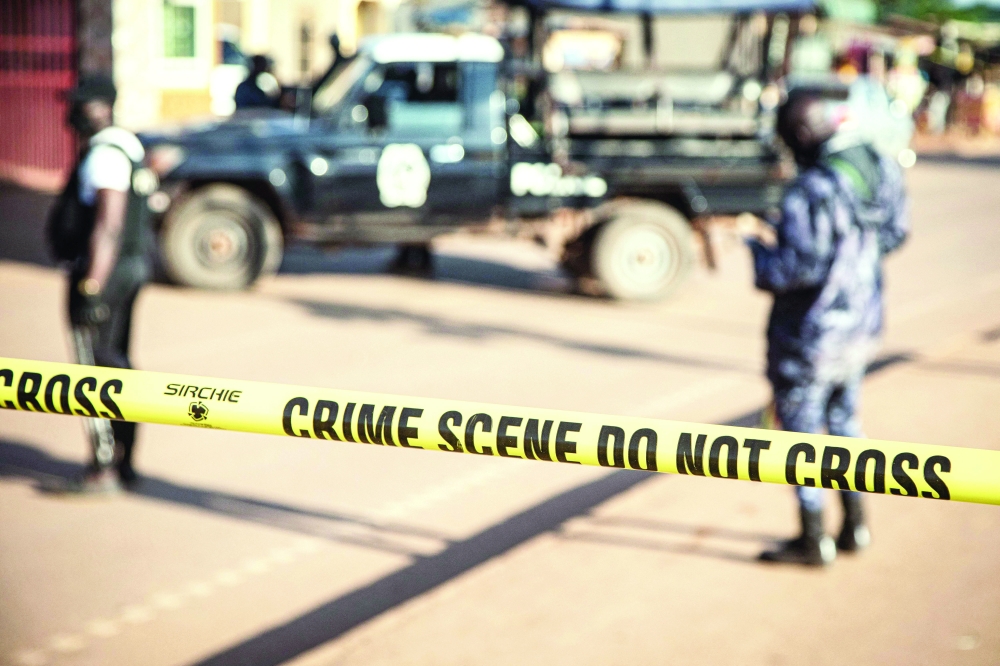 A crime scene following a bomblast last night is secured by the Ugandan police in Kampala. - AFP