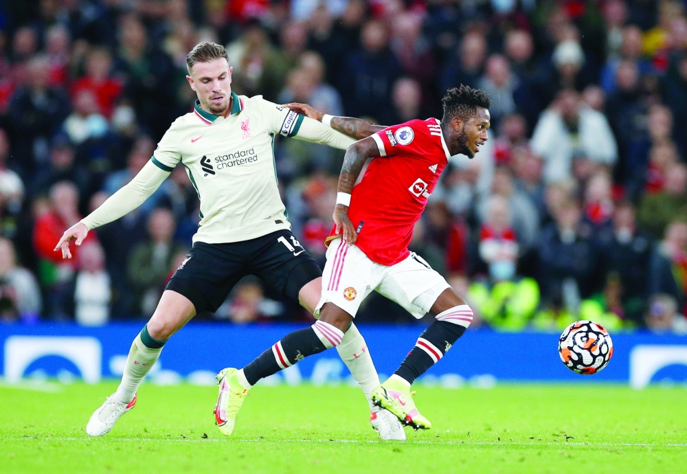 Liverpool's Jordan Henderson in action with Manchester United's Fred. -- Reuters