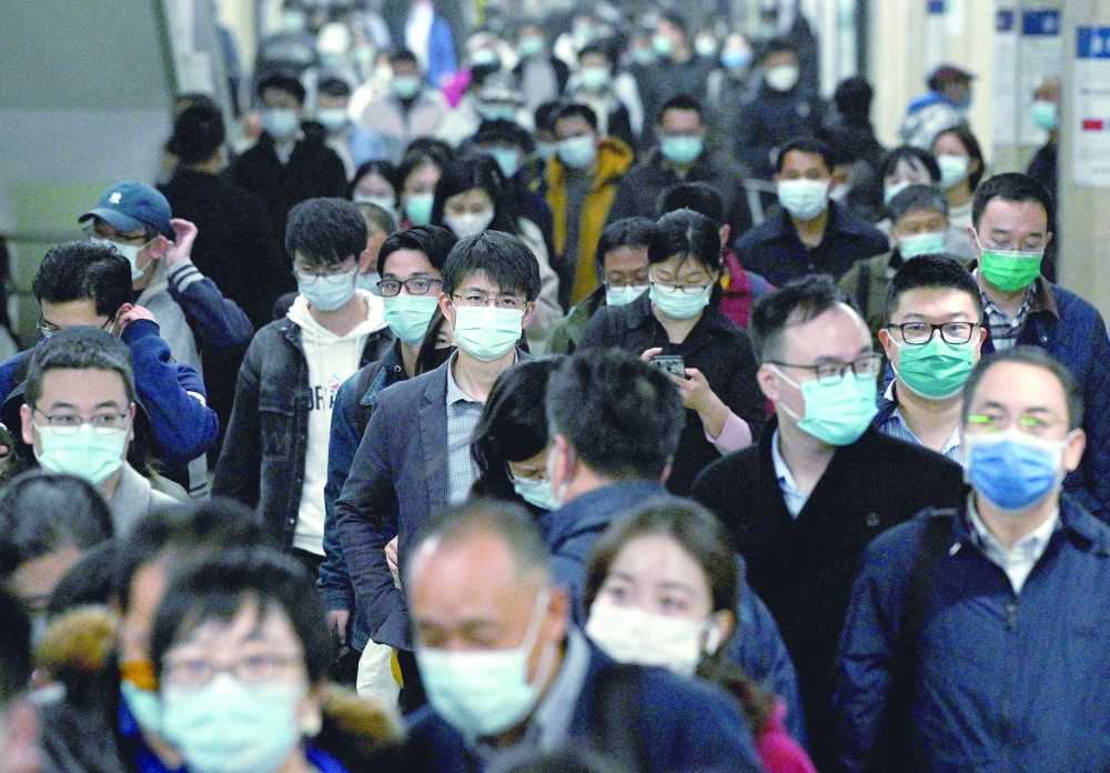Commuters travel on a Beijing subway on Monday. - AFP