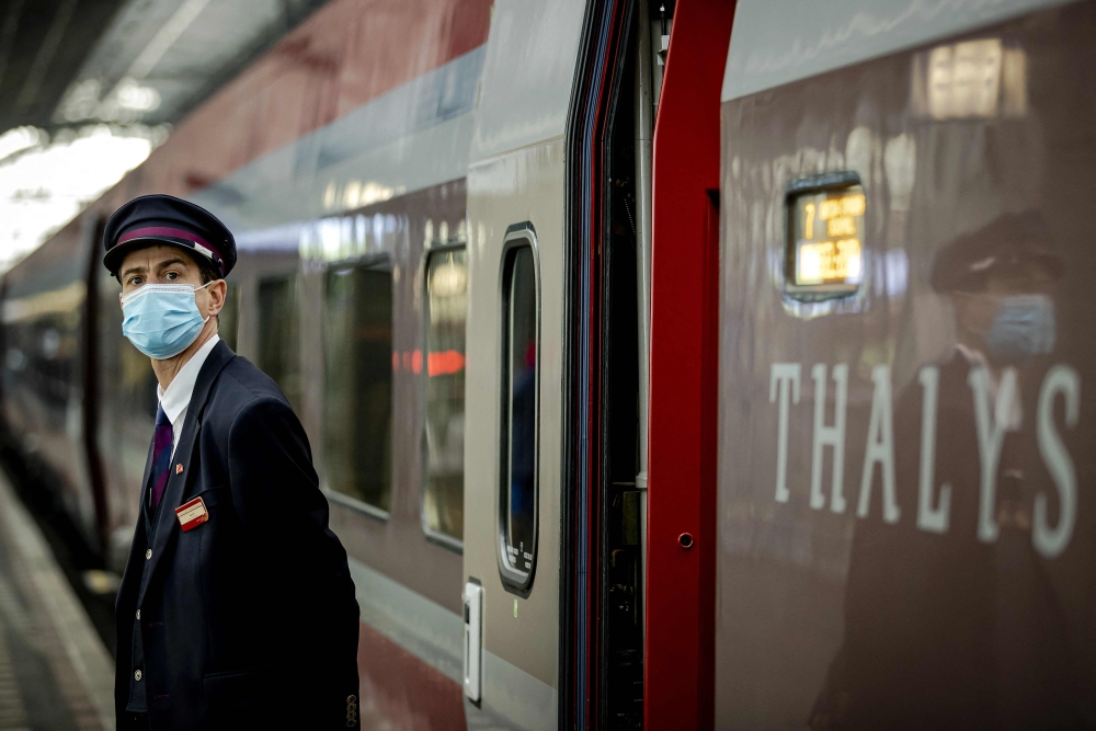 An inspector stands on the platform close to the renewed Thalys train carriage at Amsterdam Central railway station, on October 26, 2021.