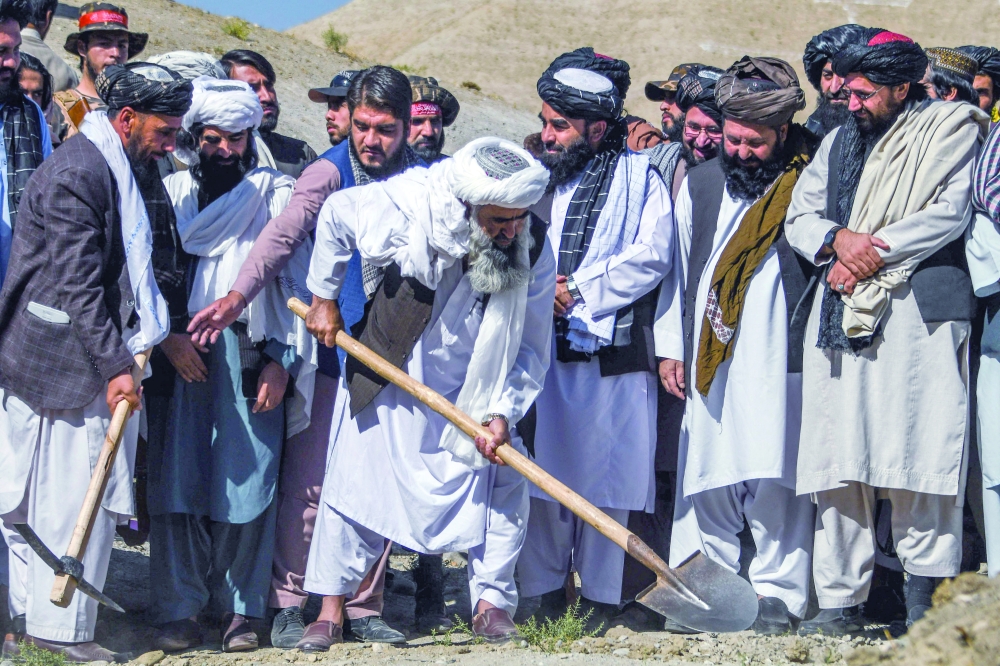 Zabihullah Mujahid (C), Chief spokesman for the Taliban attends a launch ceremony of a programme to tackle hunger in Dasht-e-Padula of southern Kabul. - AFP