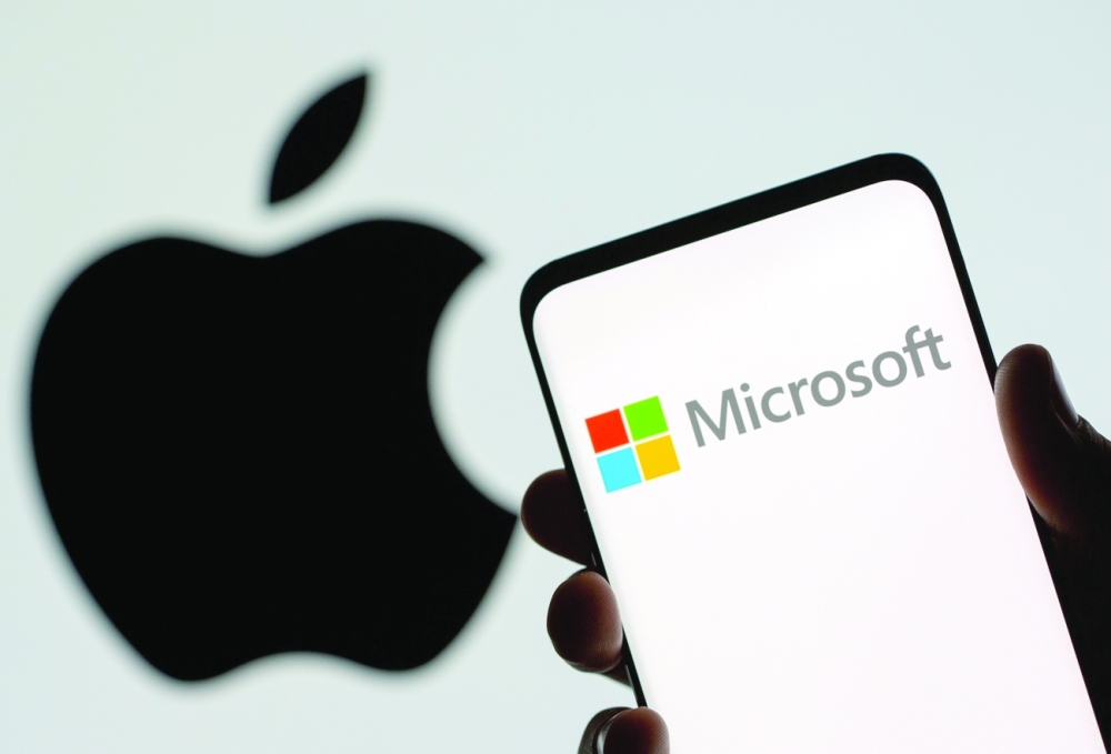 FILE PHOTO: Microsoft logo is seen on the smartphone in front of displayed Apple logo in this illustration taken