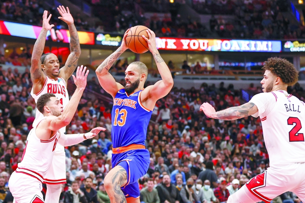 New York Knicks guard Evan Fournier (13) goes to the basket against Chicago Bulls guard Zach LaVine (8) and forward DeMar DeRozan (11). -- USA Today Sports
