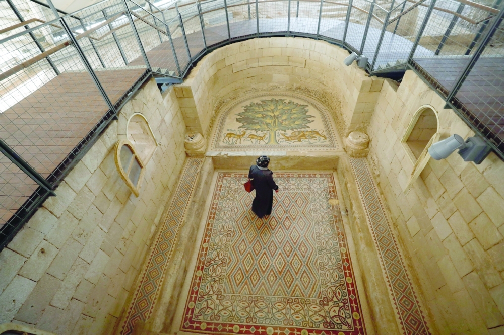 A Palestinian visits Hisham's Palace that has one of the largest mosaic panels in the world after it was opened to the public. - Reuters