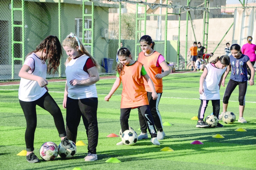 Iraqi girls take part in a training session at the Bartalla sports club in Bartalla town. - AFP