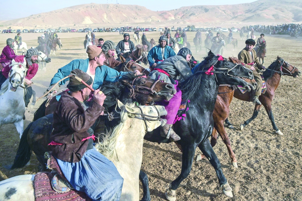 Horsemen competing during buzkashi at Qara Shabagh on the outskirts of Aybak in Samangan Province. - AFP