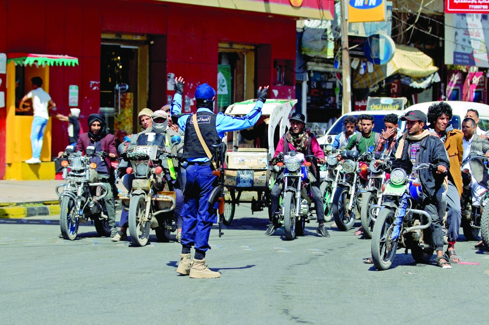 Yemeni police officers control traffic in the capital Sanaa on Tuesday. - AFP