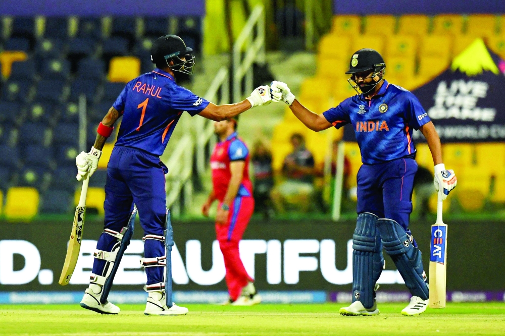India's KL Rahul (L) and Rohit Sharma bump their fists after a six during the match against Afghanistan in Abu Dhabi on Wednesday. — AFP