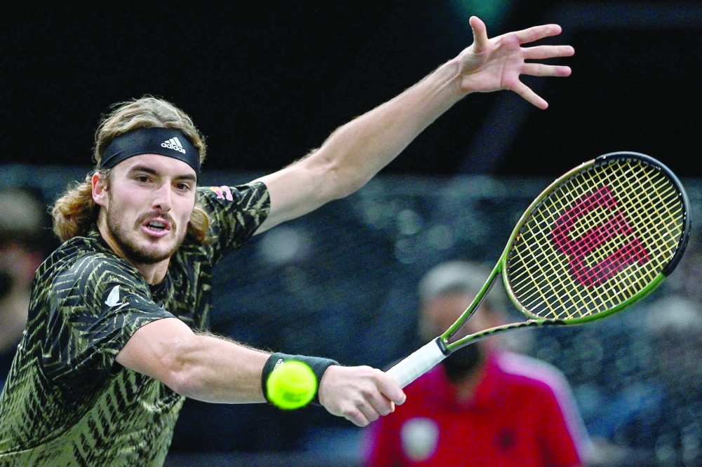 Greece's Stefanos Tsitsipas returns the ball to Australia's Alexei Popyrin during their men's singles tennis match. -- AFP