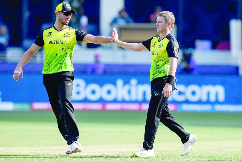 Australia's Adam Zampa (R) celebrates with teammates after the dismissal of Bangladesh's Mustafizur Rahman. -- AFP