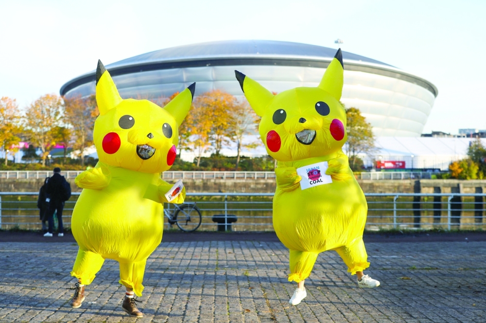 People dressed as a Pikachu protest against the funding of coal by Japan, near the UN Climate Change Conference (COP26) venue, in Glasgow on Thursday. -- Reuters