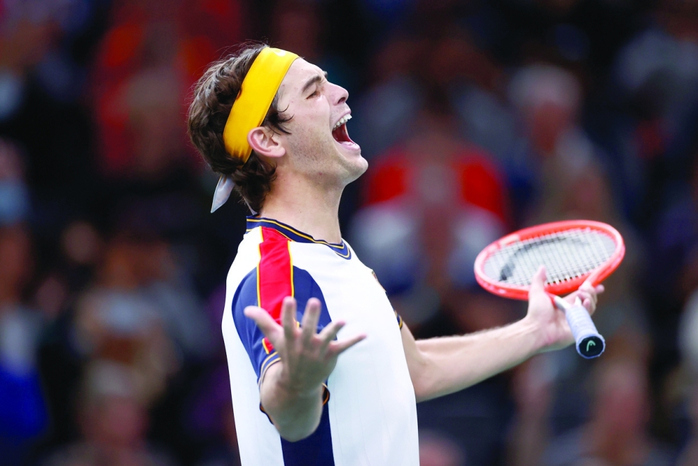 Taylor Fritz of the US celebrates winning his round of 16 match against Britain's Cameron Norrie. -- Reuters