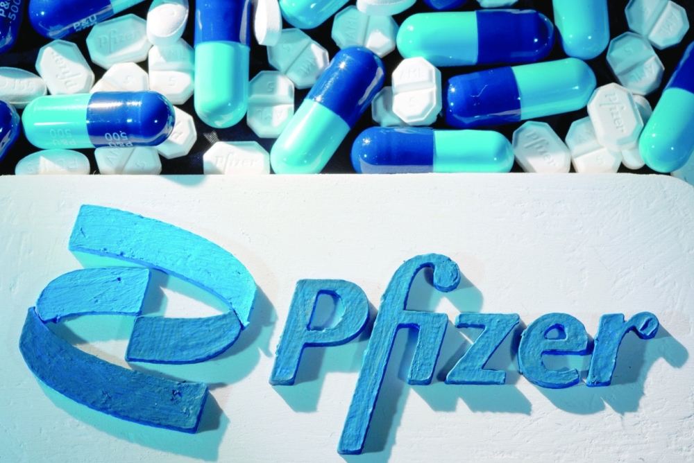 A 3D printed Pfizer logo is placed near medicines from the same manufacturer in this illustration. - Reuters