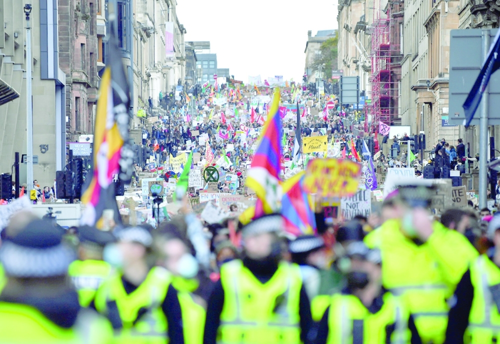 Police officers walk ahead of the Fridays for Future march during the UN Climate Change Conference (COP26), in Glasgow, on Friday. - Reuters