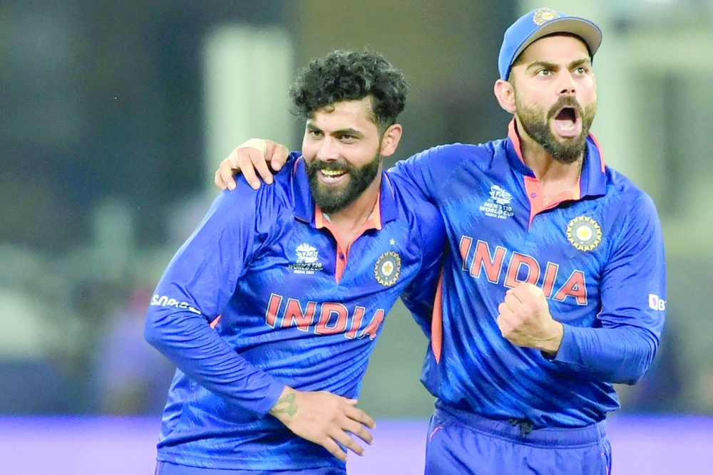 India's Ravindra Jadeja (L) celebrates with captain Virat Kohli. -- AFP