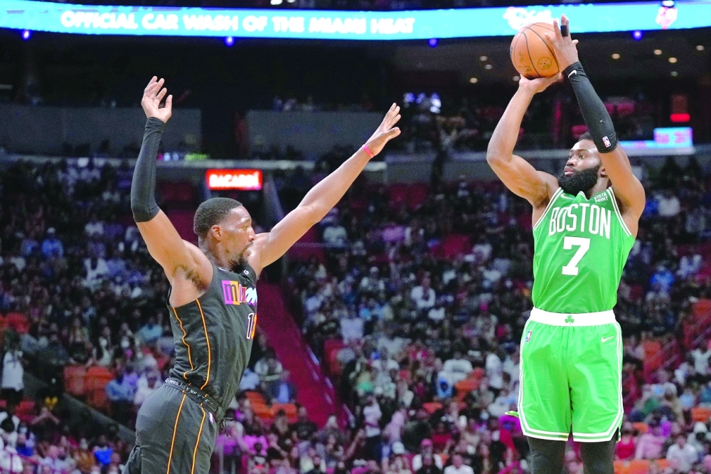 Boston Celtics guard Jaylen Brown (7) shoots over Miami Heat center Bam Adebayo (13) during the second half at FTX Arena. -- USA Today Sports
