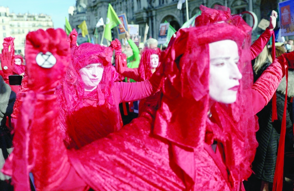 Red Rebel Brigade members, an international performance artivist troupe, demonstrate in central Paris on Saturday. - AFP