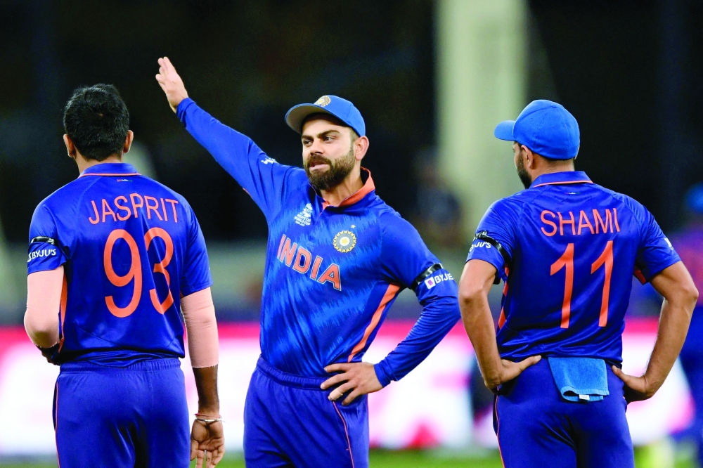 India's captain Virat Kohli (C) talks to teammates Jasprit Bumrah (L) and Mohammed Shami. -- AFP