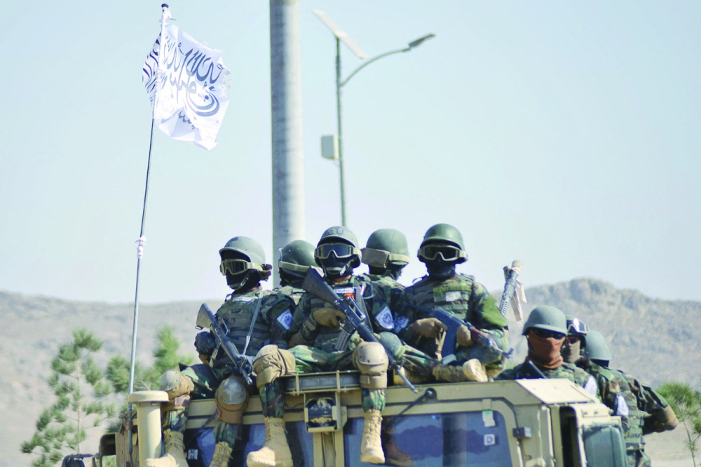 Taliban military from the Al Badr unit sit on armed vehicles during a parade in Kandahar on Tuesday. - AFP