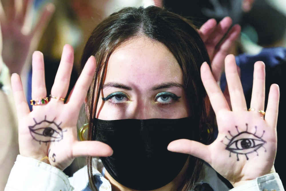 A person gestures as people protest during the UN Climate Change Conference (COP26) in Glasgow on Wednesday. -- Reuters