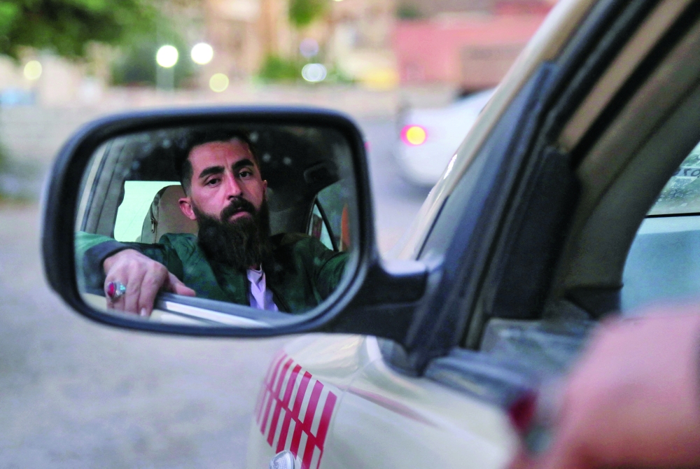 Himen Gabriel, a taxi driver who wants to immigrate to Europe, is pictured during an interview in Arbil. - AFP