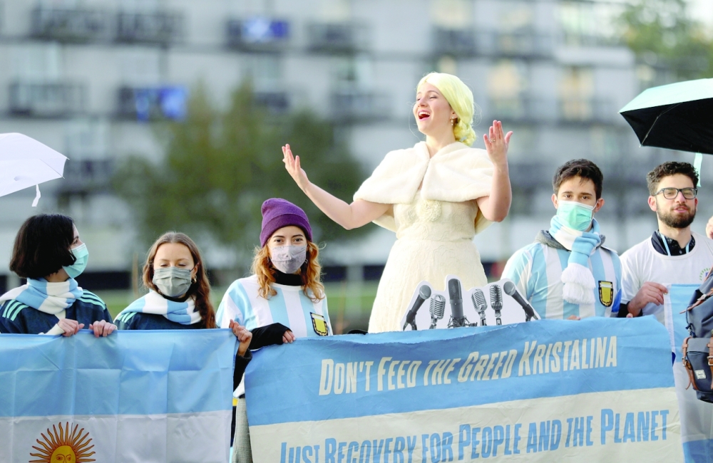 Protesters sing a climate version of 'Don't cry for me Argentina' outside the COP26 venue in Glasgow, Scotland, on Thursday. - Reuters