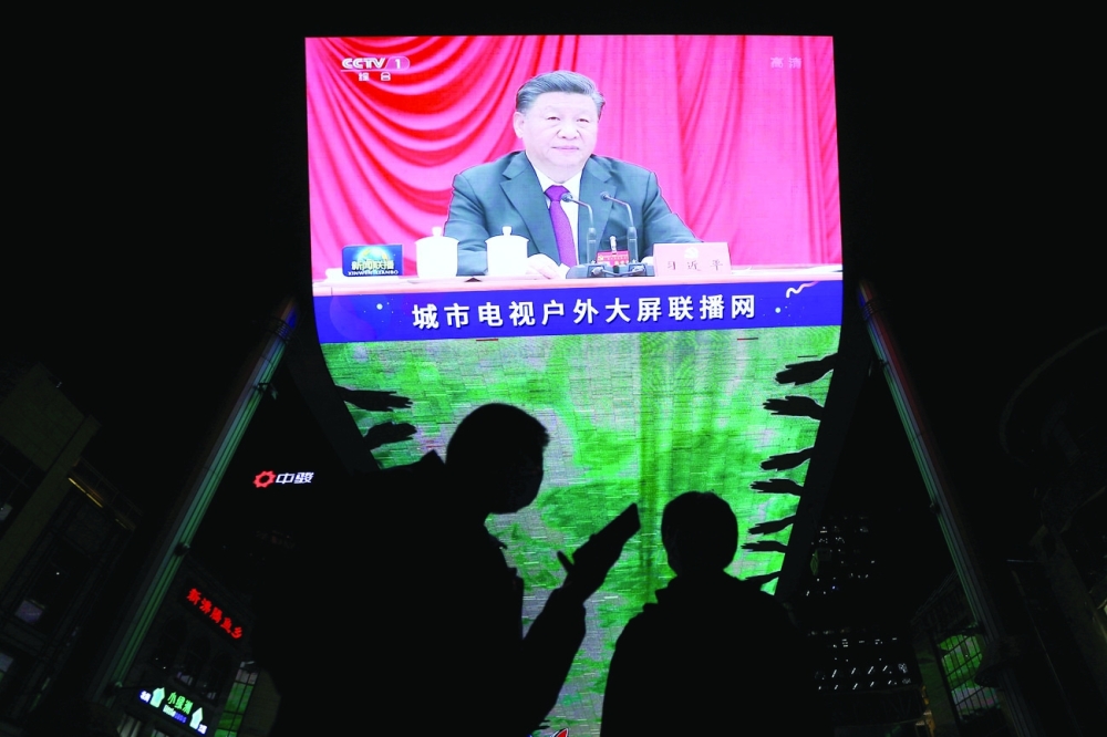 A giant screen shows President Xi Jinping attending the sixth plenary session of the 19th Central Committee of the Communist Party of China (CPC), in Beijing, on Thursday. - Reuters