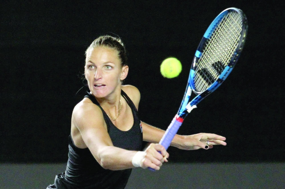 Czech Republic's Karolina Pliskova returns the ball to Spain's Garbine Muguruza. -- AFP