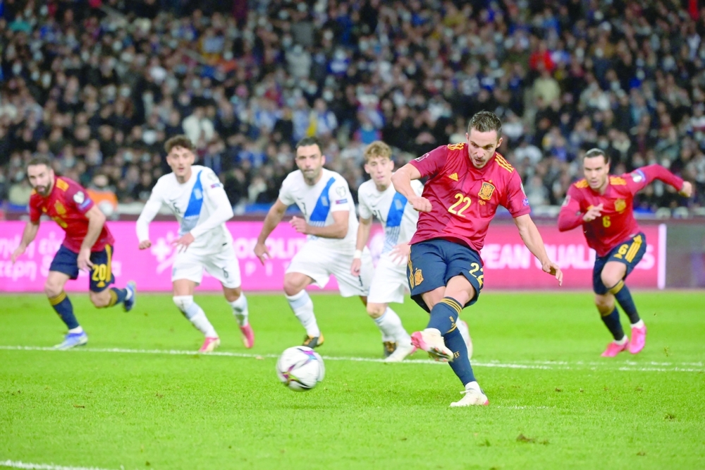 Spain's forward Pablo Sarabia scores a penalty during the FIFA World Cup Qatar 2022 qualification match. -- AFP
