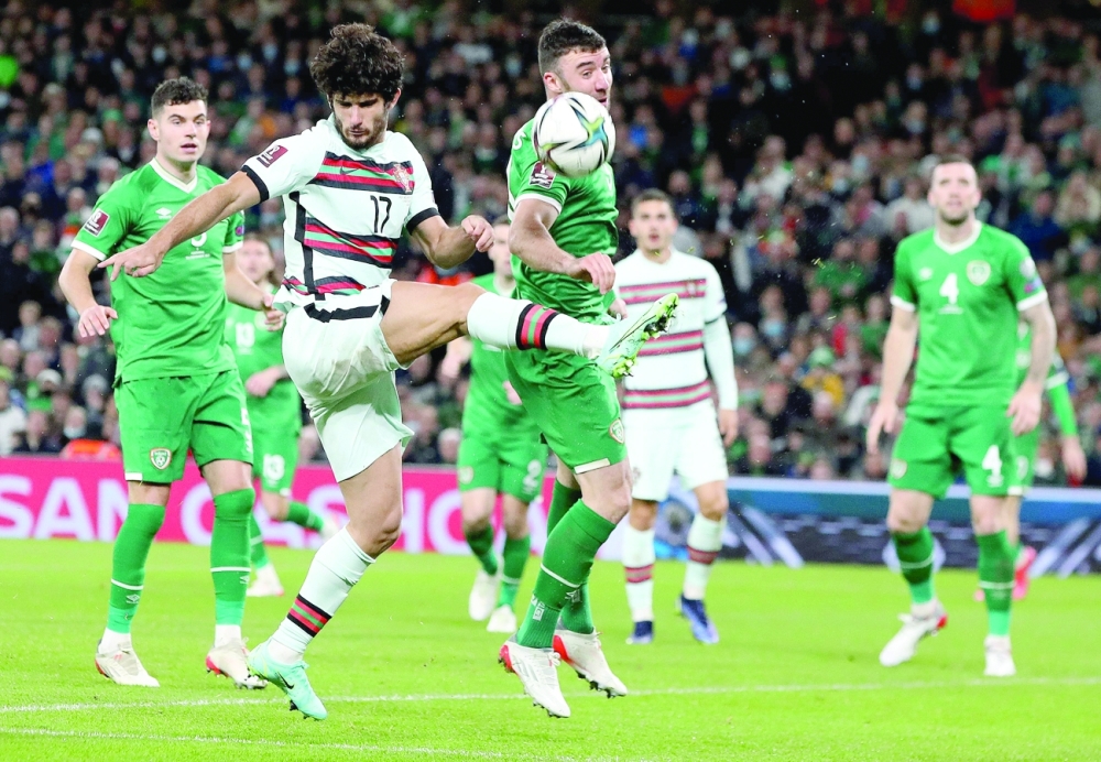 Republic of Ireland's Enda Stevens (C) blocks a cross by Portugal's striker Goncalo Guedes (2L) during the FIFA World Cup Qatar 2022 qualifying round Group A match. -- AFP