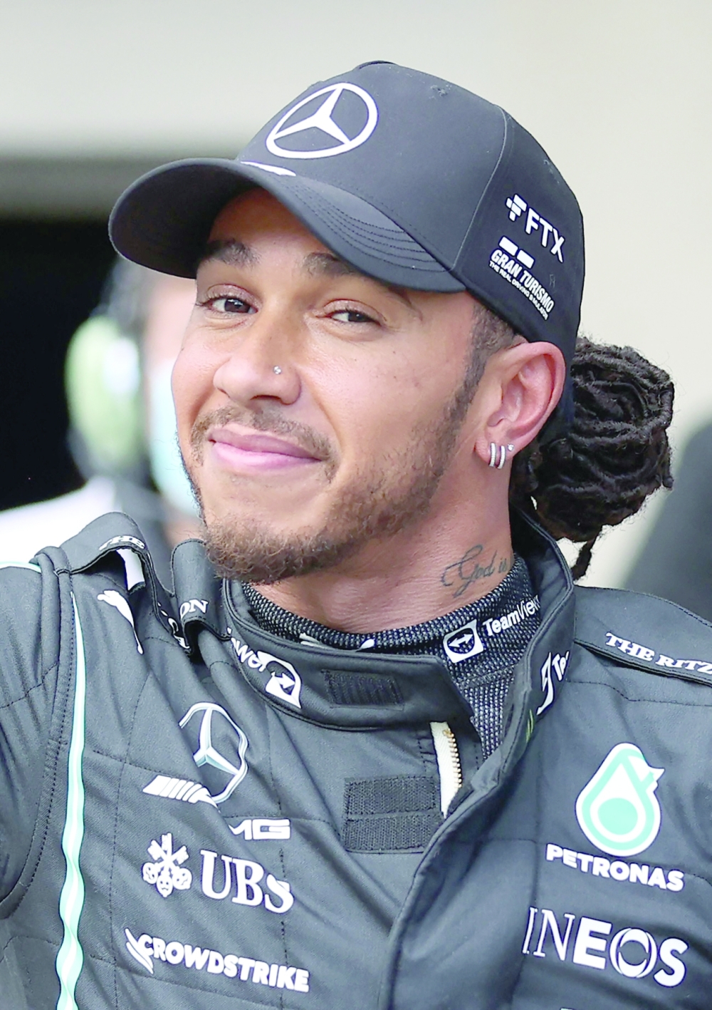Mercedes' driver Lewis Hamilton smiles after winning the qualifying session for Brazil's Formula One Sao Paulo Grand Prix. -- AFP