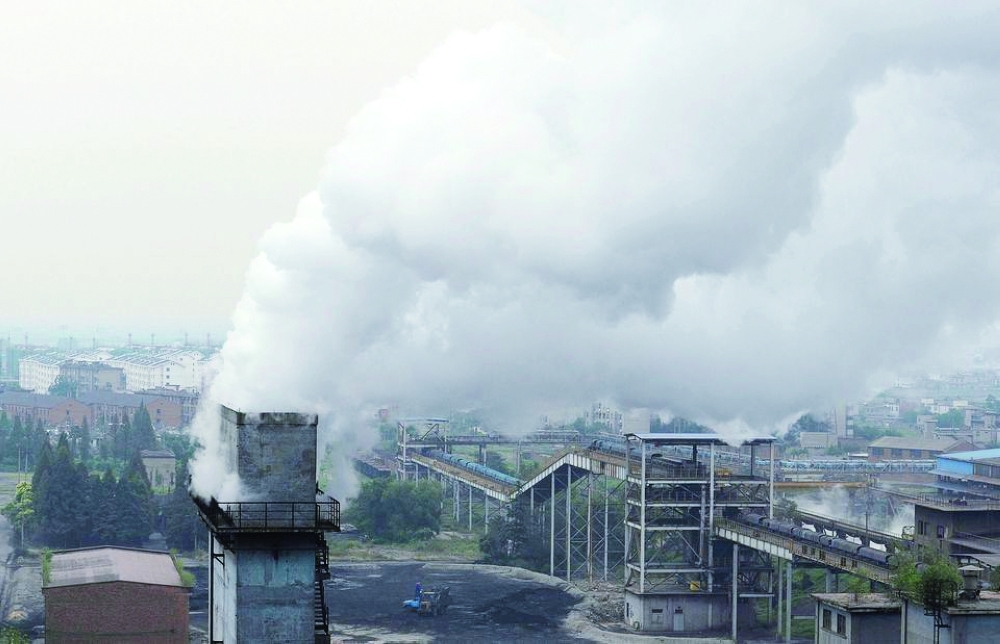 Smoke billows from a chimney at a coking factory in Hefei, Anhui province, China. — Reuters