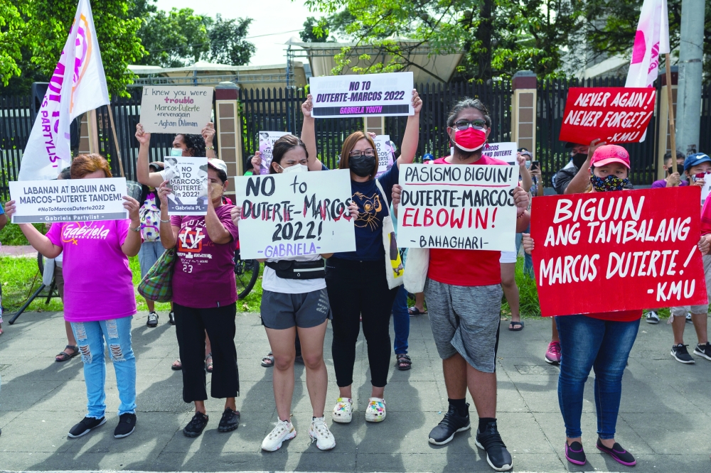 Demonstrators hold placards during a protest following the vice presidential bid of Davao City Mayor Sara Duterte, daughter of Philippine President Rodrigo Duterte, for the 2022 national elections, in Quezon City, Metro Manila. - Reuters
