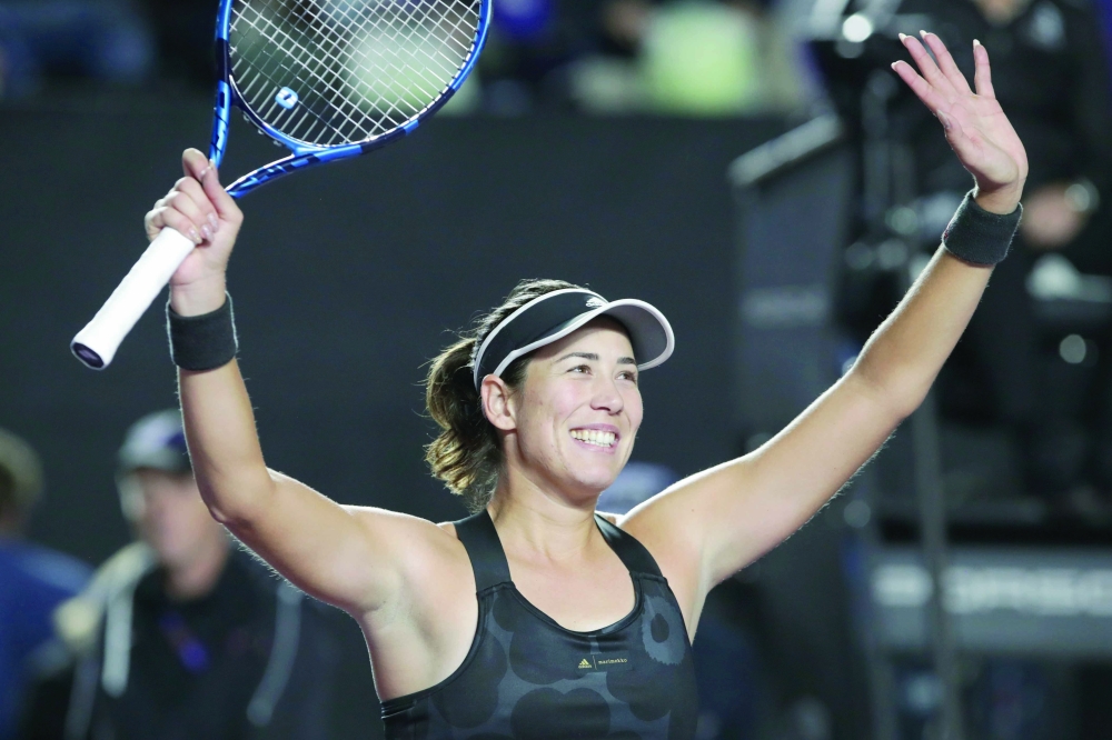 Spain's Garbine Muguruza celebrates after winning her group stage match against Estonia's Anett Kontaveit. -- Reuters