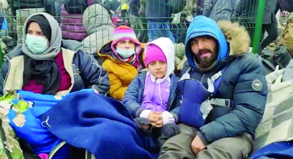 Taman's father, Sangar, speaks about his family's situation, at a migrants' camp near Bruzgi-Kuznica checkpoint on the Belarusian-Polish border. - AFP