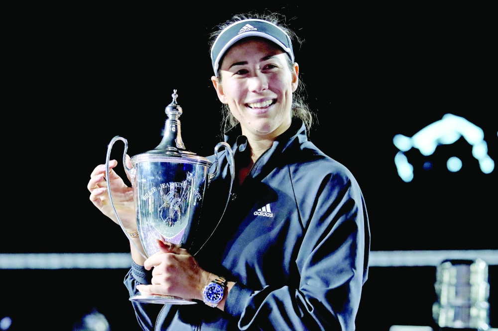 Spain's Garbine Muguruza celebrates with the trophy. -- AFP