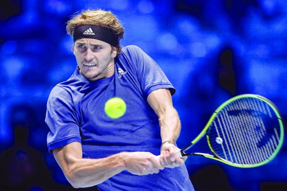 Germany's Alexander Zverev returns a shot to Poland's Hubert Hurkacz during their first round singles match of the ATP Finals. -- AFP