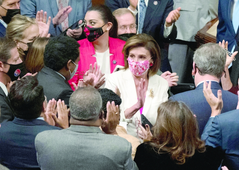 Members applaud Speaker of the House Nancy Pelosi (C) after she announced the passage of the Build Back Better Act on the floor of the House on Capitol Hill in Washington, DC, on Friday. - AFP 