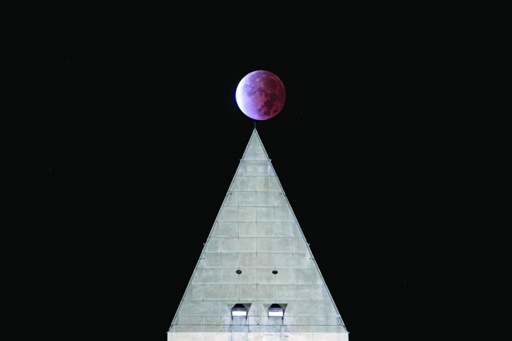 The Beaver 'blood' Moon partial lunar eclipse is seen above the Washington Monument in Washington on Friday. -- Reuters