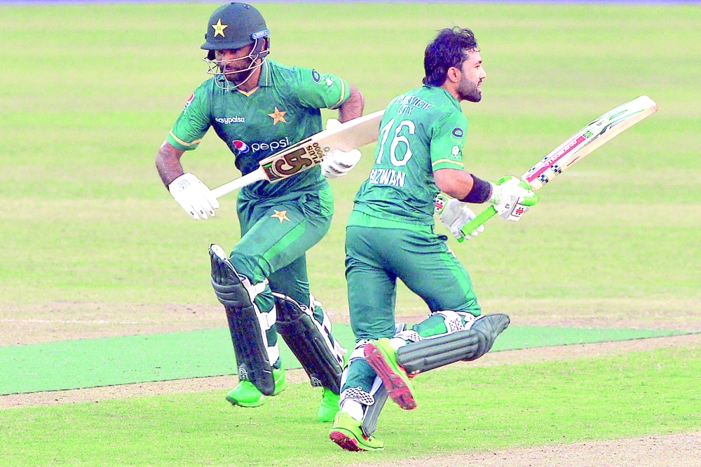 Pakistan's Mohammad Rizwan (R) and Fakhar Zaman run between the wickets. -- AFP