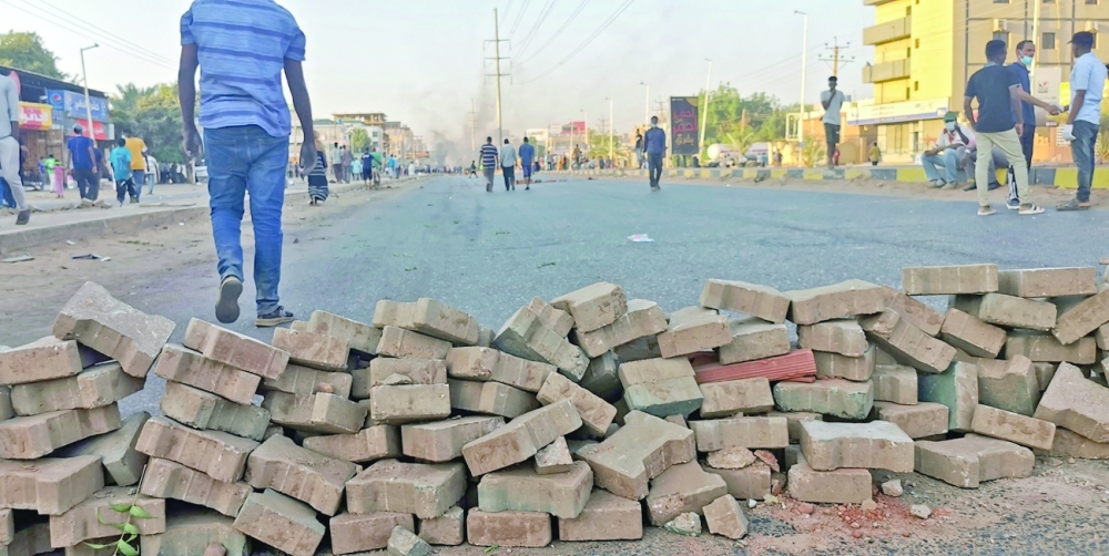 Sudanese anti-coup protesters barricade a road amid ongoing protests against last month's widely condemned military takeover in Khartoum. - AFP