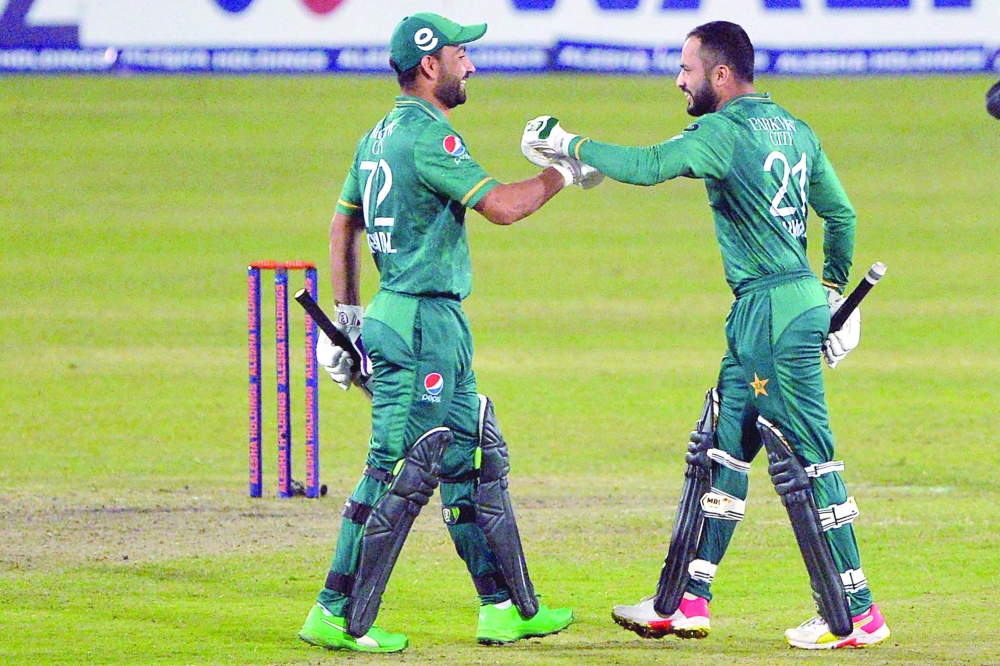 Pakistan’s Mohammad Nawaz (R) greets Khushdil Shah after winning the third T20I against Bangladesh. — AFP