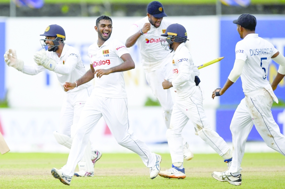 Sri Lanka’s Lasith Embuldeniya (2L) and team-mates celebrate their victory at the end of the fifth day of the first Test. — AFP