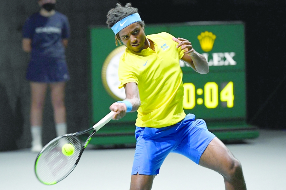 Sweden's Elias Ymer returns the ball to Canada's Steven Diez during their Davis Cup group stage match. -- AFP