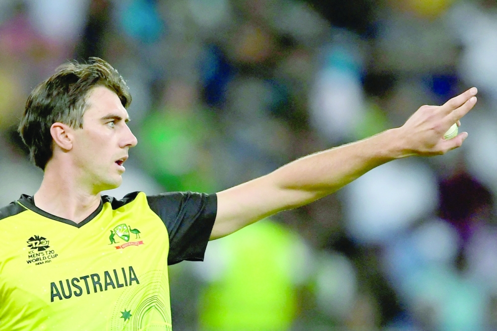In this file photo taken on November 11, 2021 Australia's Pat Cummins adjusts the field during the ICC T20 World Cup semifinal. -- AFP