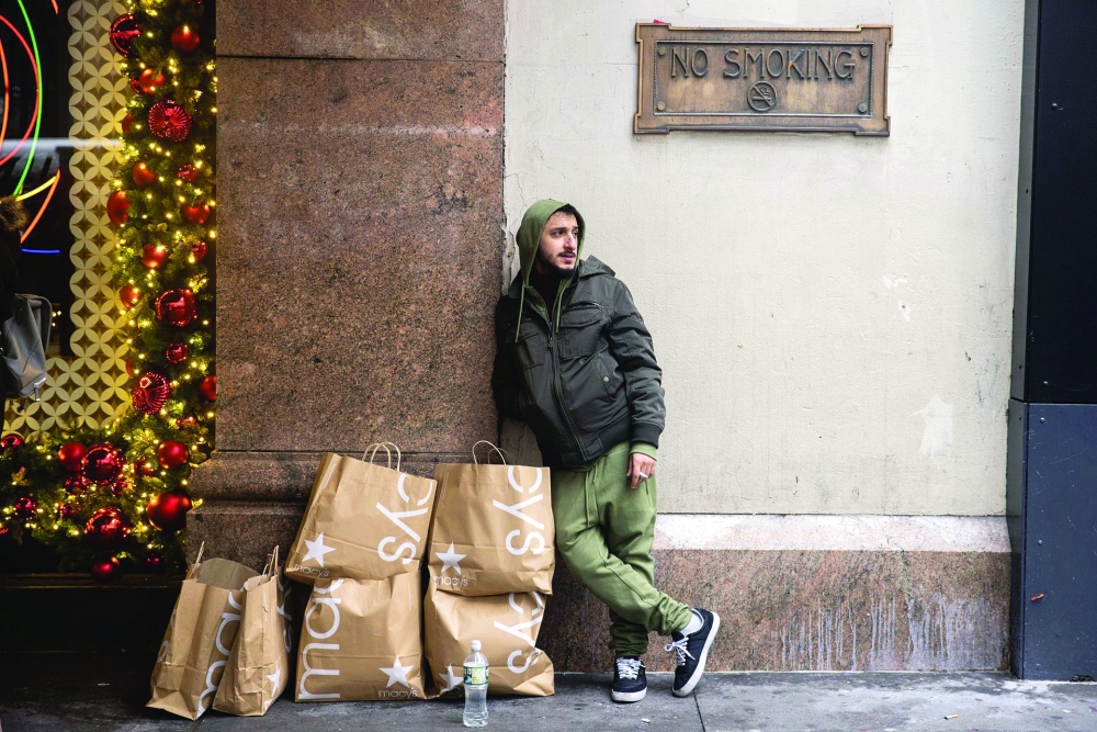 A man watches shopping bags outside Macy’s department store during Black Friday sales in the Manhattan borough of New York City, New York. — Reuters