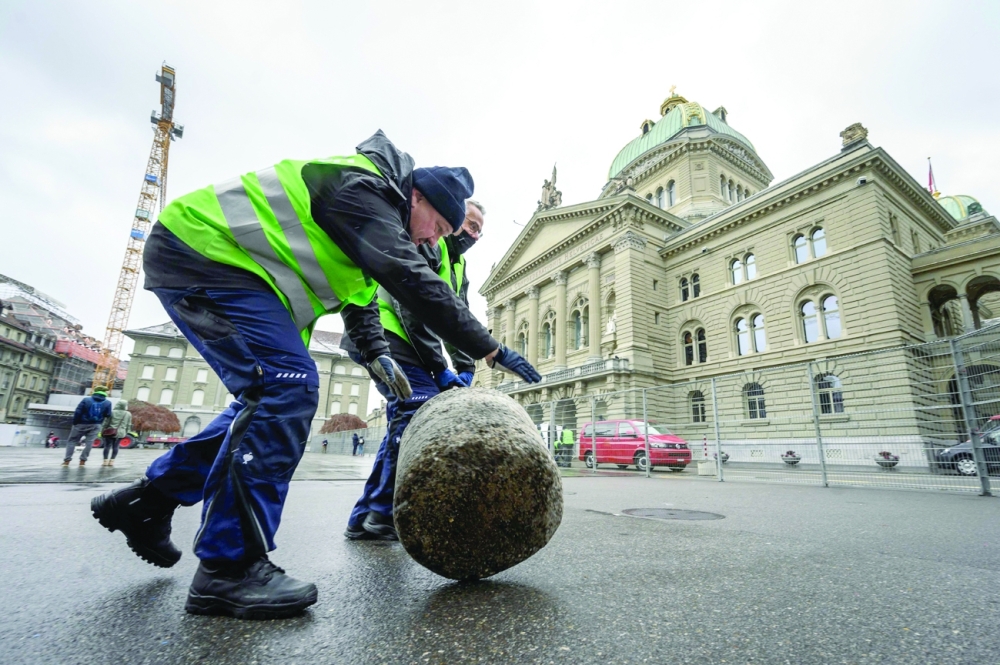 Policemen secure the Federal Place next to the House of Swiss Parliament in Bern, on Sunday ahead of the result of a nationwide vote on its Covid-19 law. - AFP