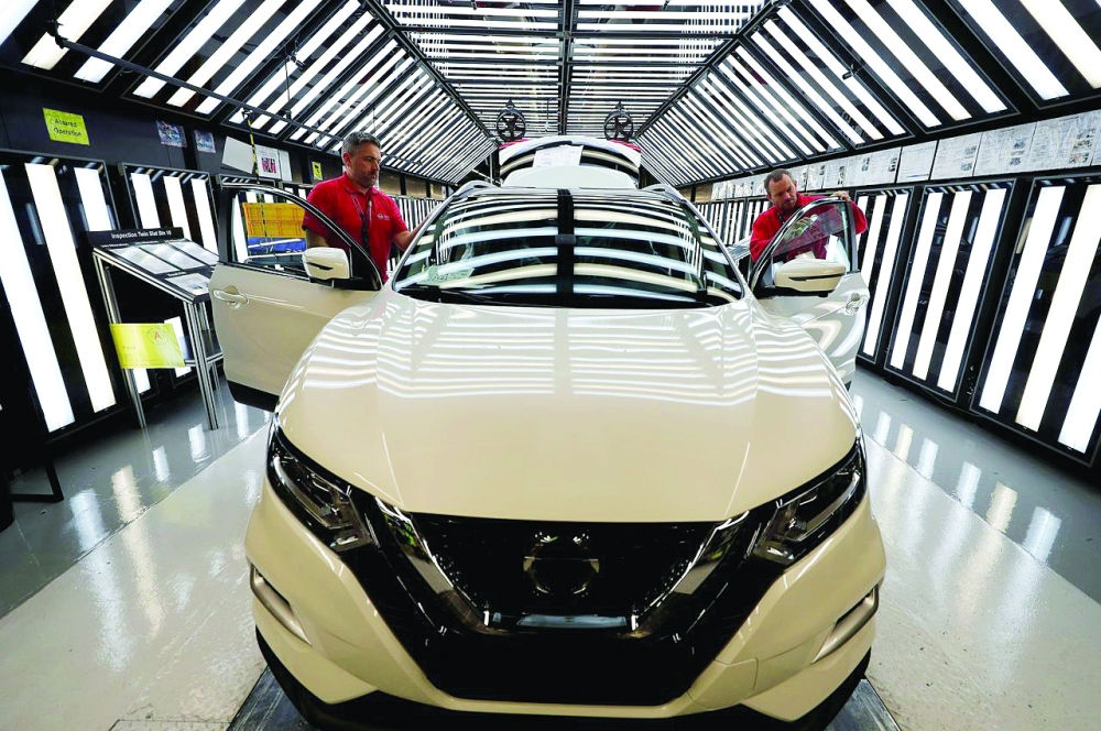Workers are seen on the production line at Nissan's car plant in Sunderland, Britain. — Reuters