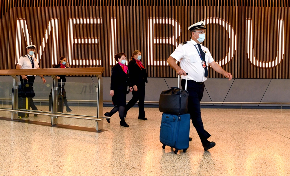 A Qantas flight crew arrive at Melbourne's Tullamarine Airport as Australia records it's first cases of the Omicron variant of Covid-19. - AFP

