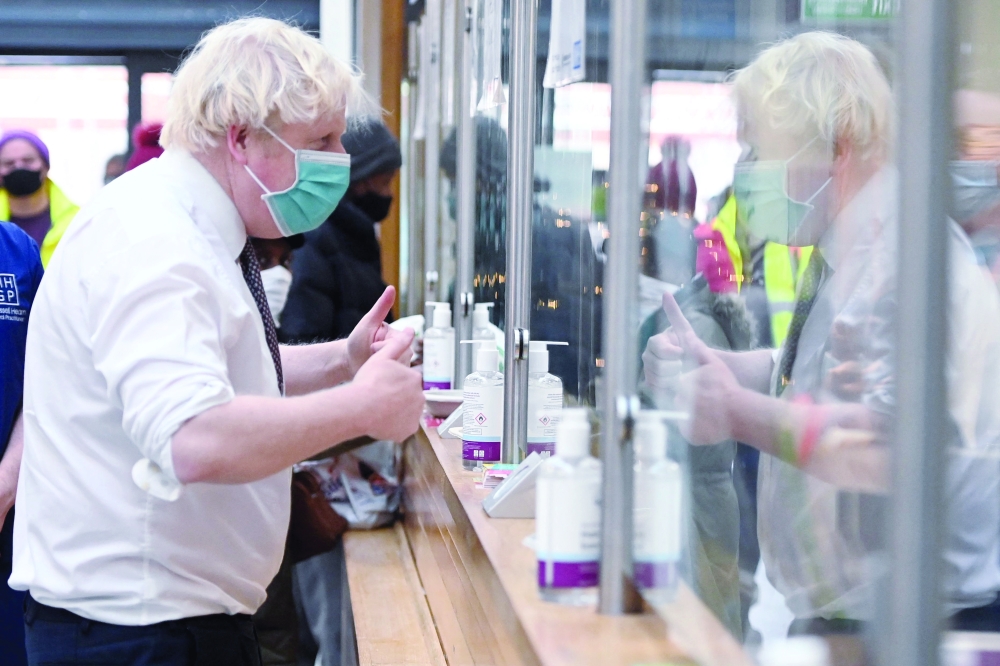 Britain's Prime Minister Boris Johnson during his visit to Lordship Lane Primary Care centre in north London to promote the NHS vaccine booster campaign. - AFP
